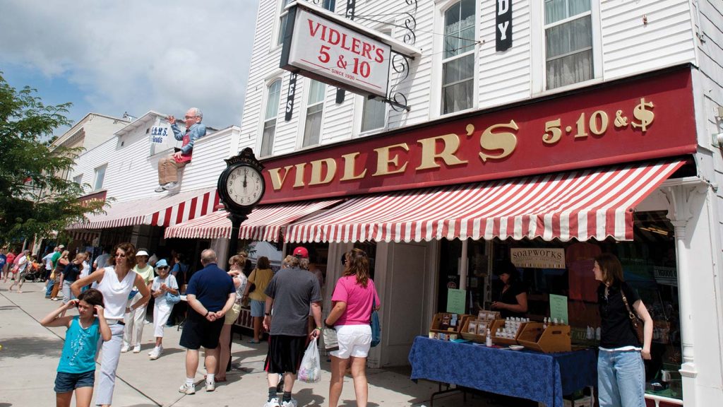Visitors stroll along historic roads as they peruse the shop front of Vidler's 5 and 10 in East Aurora.