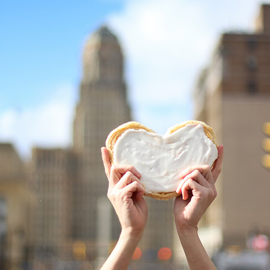 A frosting-covered pastry heart held up in downtown Buffalo