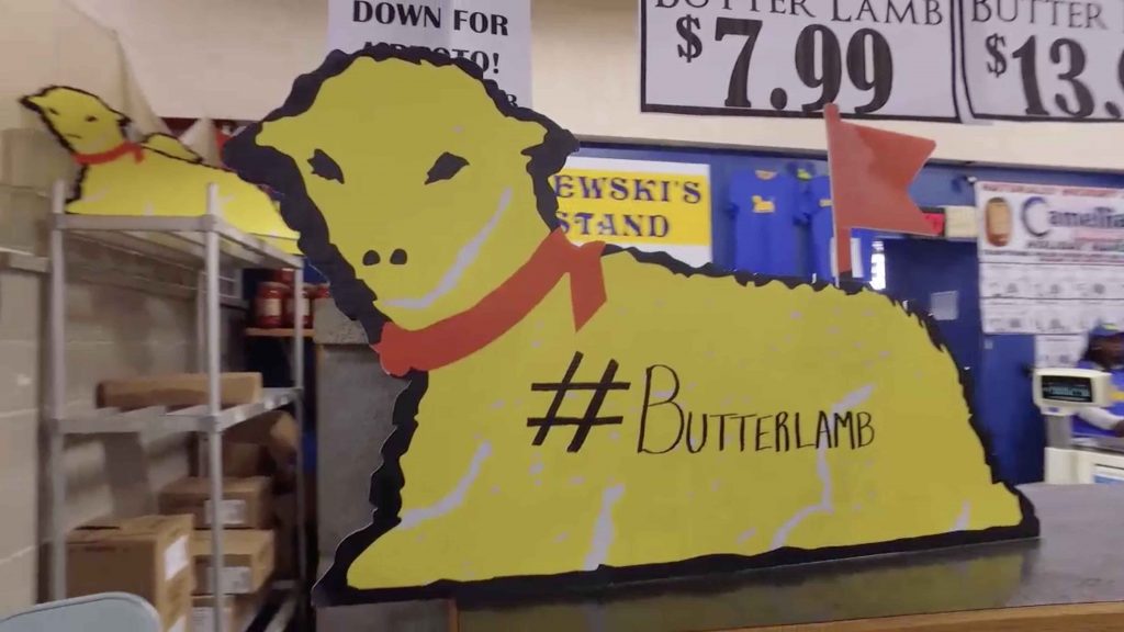 A sign displaying a butter lamb with a red ribbon at Malczewski's, a popular Buffalo shop.
