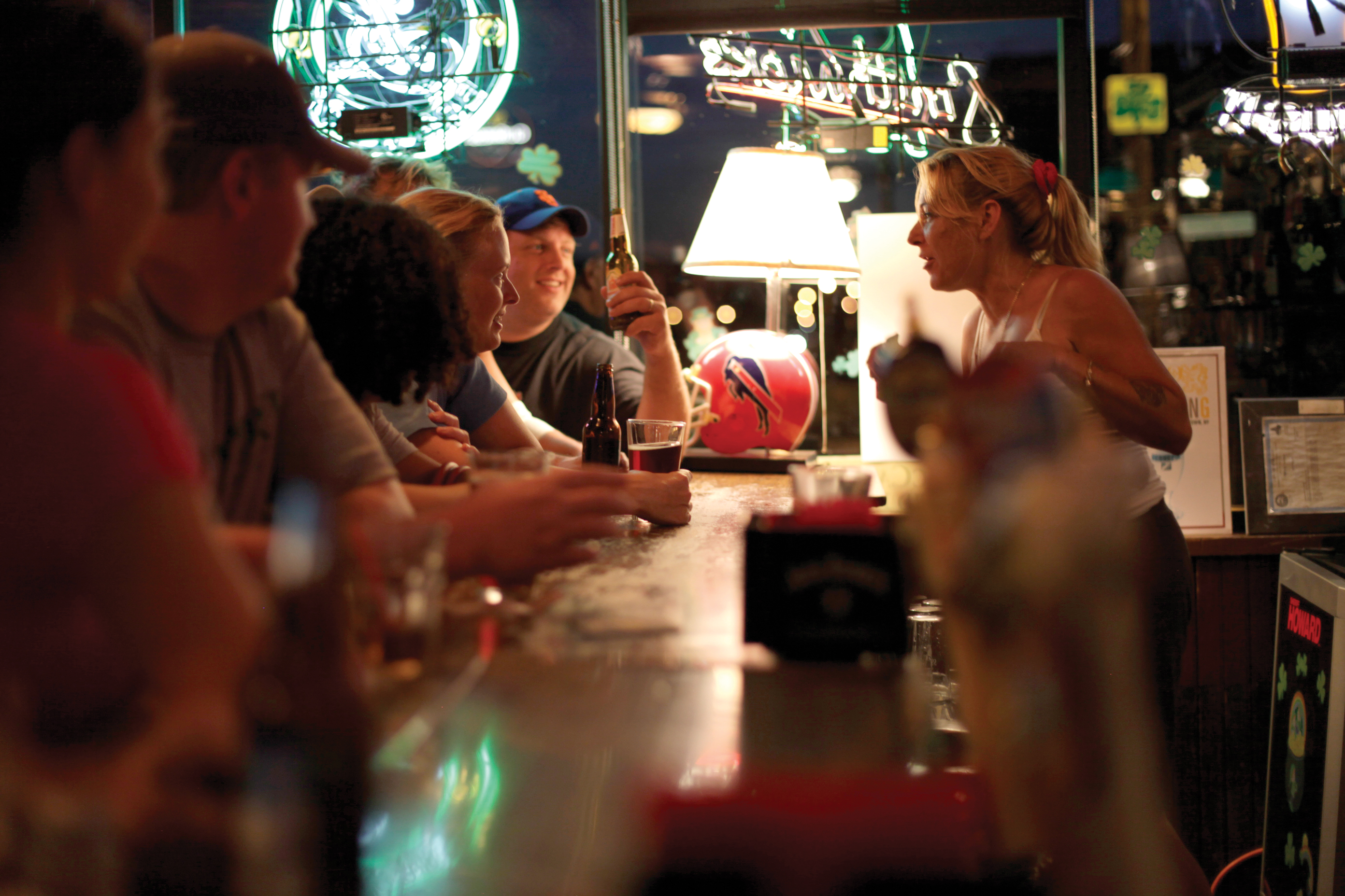 Patrons laugh and socialize at an Irish tavern during Saint Patrick's Day in Buffalo.