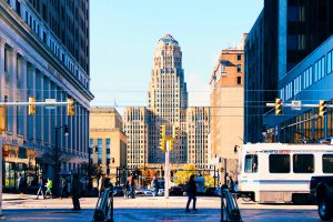 Buffalo's metro bus 20 drives through pedestrian-filled Niagara Square.