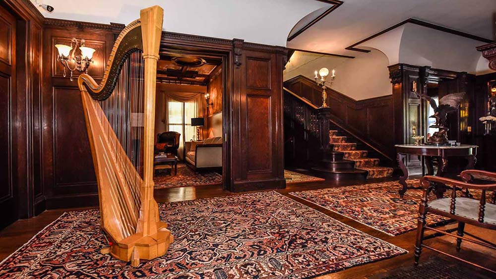 Interior shot of the common area, featuring a harp, at Inn Buffalo