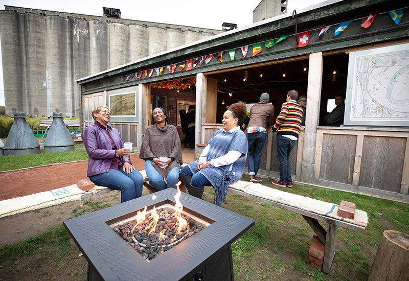 A group sitting at an ourdoor patio in Silo City: Buffalo, NY