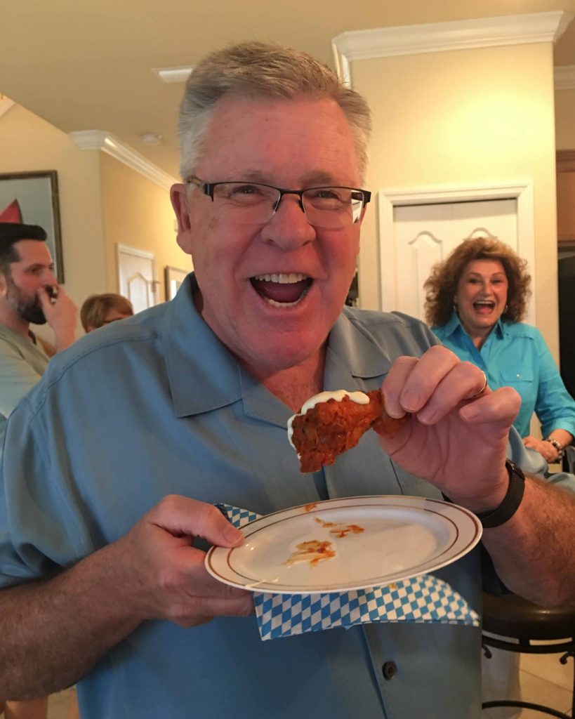 A man eating a Duff's chicken wing.