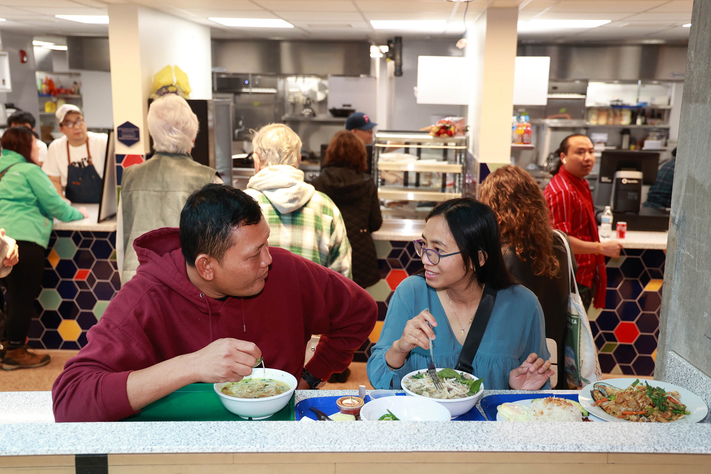 Said Zayar, of Buffalo, and Tai Win, of Hamilton, Ontario purchase dishes from three different restaurants at the West Side Bazaar as it celebrates its grand opening at its new location at 1432 Niagara Street in Buffalo, Saturday, November 4, 2023. Photo by Sharon Cantillon.